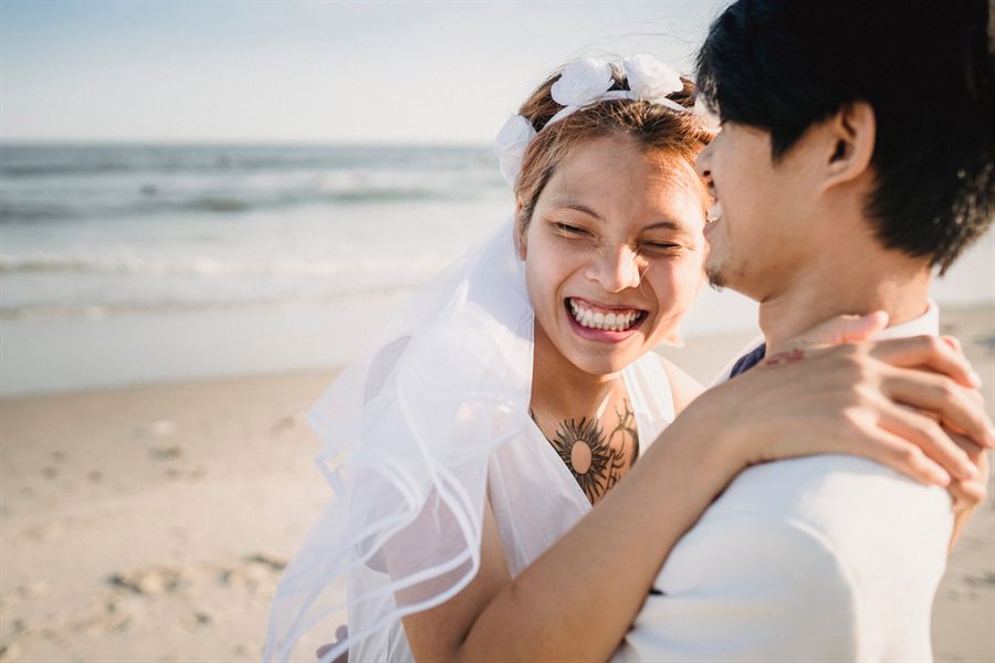 Couple laughing together on a beach