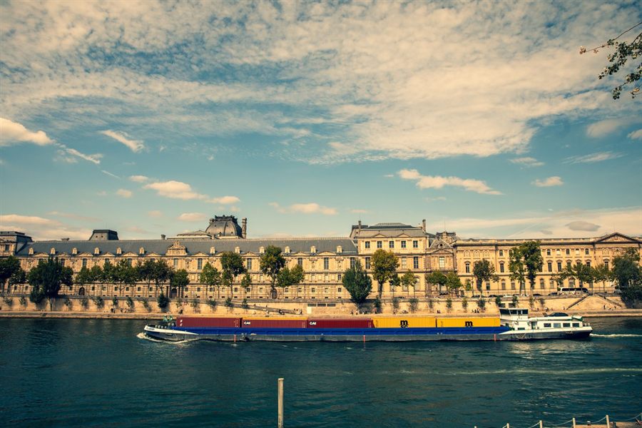 River cruise boats on a river lined with grand buildings