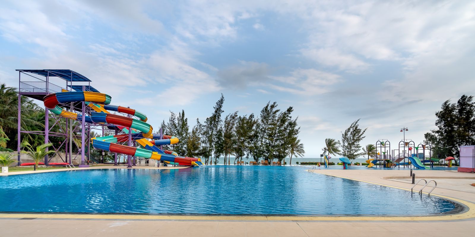 Pool with colorful water slides, a highlight of many types of cruises for families
