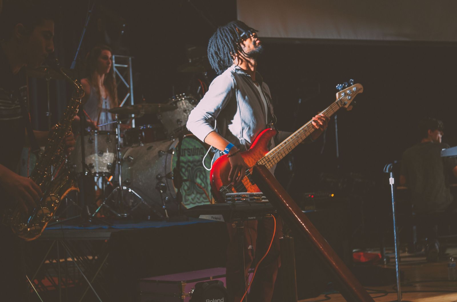 Guitarist on stage under colored lights, the kind of show on a themed cruises list